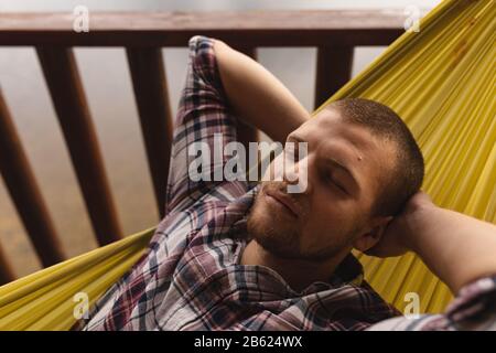 Caucasian man lying in the hammock Stock Photo