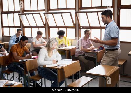 Side view of students working in class Stock Photo