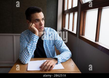 Front view of student looking through the window Stock Photo