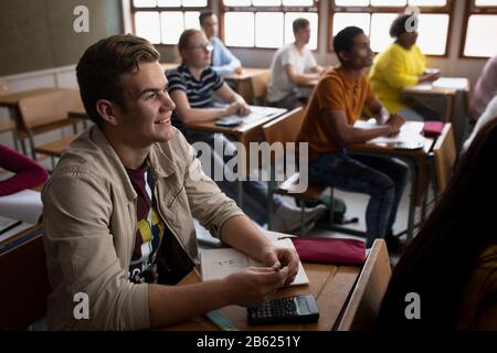 Side view of students listening in class Stock Photo