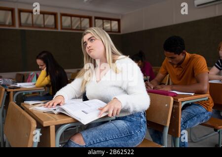 Side view of students working in class Stock Photo
