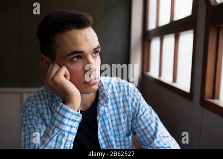 Front view of student looking through the window Stock Photo