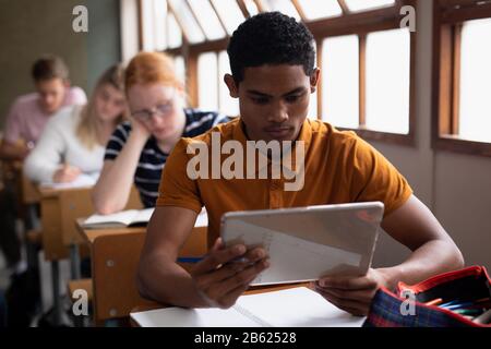 Front view of student using a touch pad in class Stock Photo