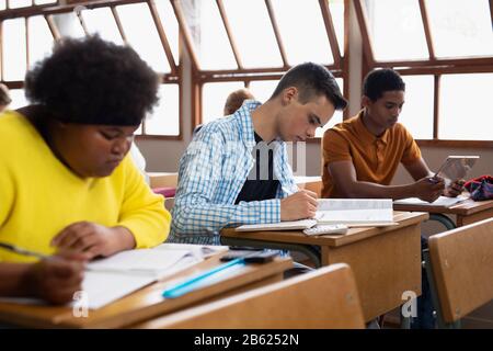Side view of students working in class Stock Photo