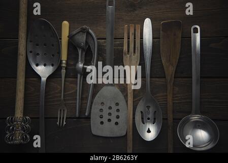 Collection of vintage cooking instruments on a rustic board Stock Photo