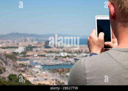 Male hands holding smartphone trying to take travel photo Stock Photo