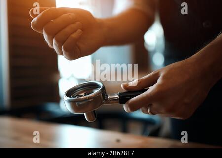 talented coffee shop worker has chosen best beans for espresso, close up cropped photo Stock Photo