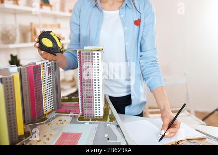 pleasant young woman developing interior , working on the planning of building, close up cropped photo. development of new ecological area Stock Photo