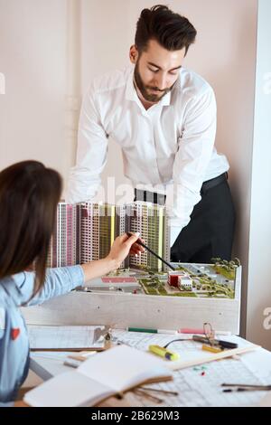 young man and woman having a discussion about new building complex, cooperative. vertical shot. close up photo Stock Photo