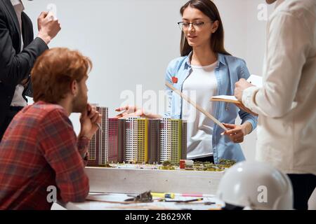 awesome beautiful talented woman holding a ruler and explaining the features of new project in the meeting, close up photo, partnership Stock Photo