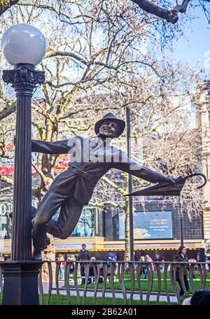 A statue of Gene Kelly in Leicester Square in March 2020 - one of a number celebrating a century of cinema - in a scene from 'Singing' in the Rain.' Stock Photo