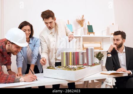 pensive thoughtful bearded leader sitting on the cahi and controlling his team's work. close up photo. management Stock Photo