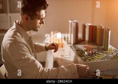 young man is responsible for designing, building houses, places, close up side view photo Stock Photo