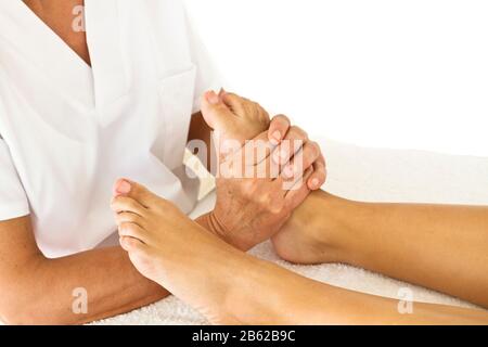 Massage and physiotherapy to a woman in her foot Stock Photo