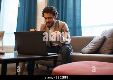 cheerful man is celebrating winning of his favourite team, close up photo. positive feeling and emotion. celebration, Stock Photo