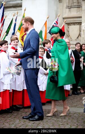 The Duke and Duchess of Sussex speak to choristers as they leave Westminster Abbey, London, following the Commonwealth Service on Commonwealth Day. Stock Photo