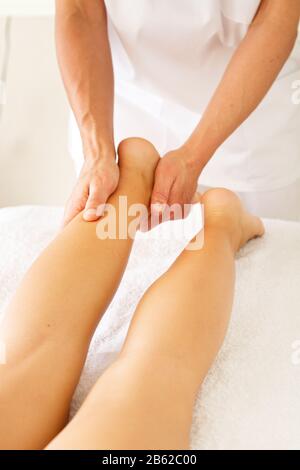 Massage and physiotherapy to a woman in her foot Stock Photo