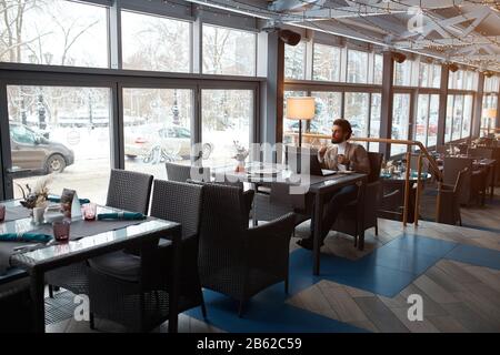 young elegant man enjoying peace and quiet, man having breakfast after difficult working day. Stock Photo