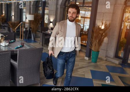 young attractive man rushing to have business meeting at the cafe, close up photo.interest concept. Stock Photo