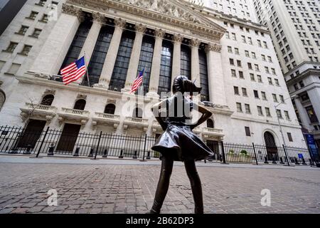 NEW YORK, USA - FEBRUARY 02, 2020: The 'Fearless Girl' statue standing at its new location facing the New York Stock Exchange. Stock Photo
