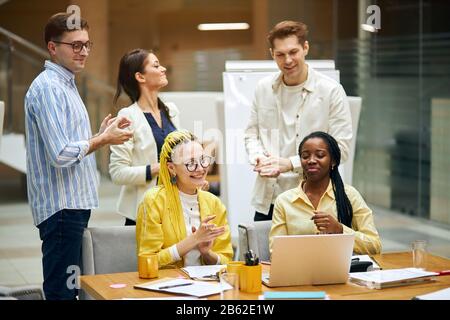young successful mixed race team rejoising at bargain, close up photo. team has coped with problem Stock Photo