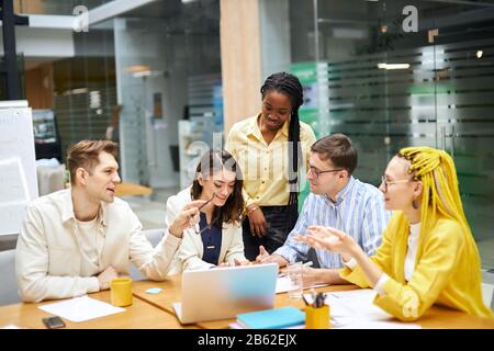 young active designers discussing creative ideas, developing their barnd name. close up photo, team, friendship, Stock Photo