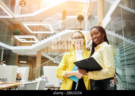smiling charming women in stylish clothes posing to the camera in the office. close up photo, job, profession, occupation, working with a clients Stock Photo