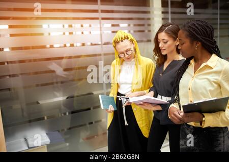 three hardworking ambitious employees discussing problemd, ideas, making up a plan, close up photo. copy space. job, profession, occupation Stock Photo