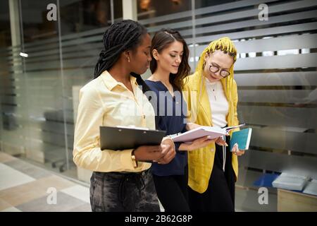 ambitious women concentrated on working at the office, busy atmosphere at workplace. close up side view photo Stock Photo