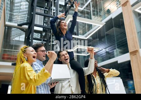the luckiest business people in the world, side view photo, party in the office. a state of euphoria. motivation concept, everything is possible Stock Photo