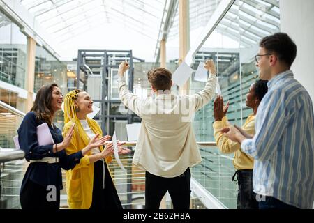 business people are happy because of successful project realization in the office. Stock Photo