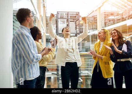 prosperous business, guy has won the lottery, close up photo.funny guy with closed eyes looking up, raising his arms Stock Photo