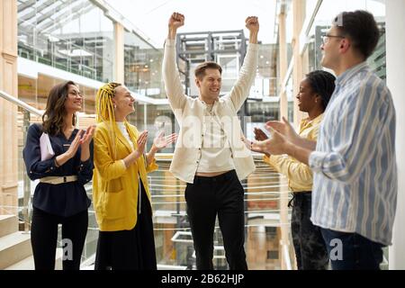 excited business coworkers are happy as company has success achievement. close up photo. man exulting hissuccess Stock Photo