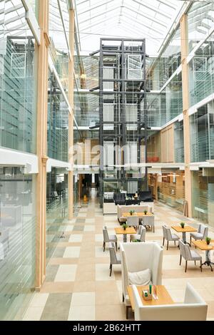 modern wooden desks, chairs under the glass ceiling. full length photo Stock Photo