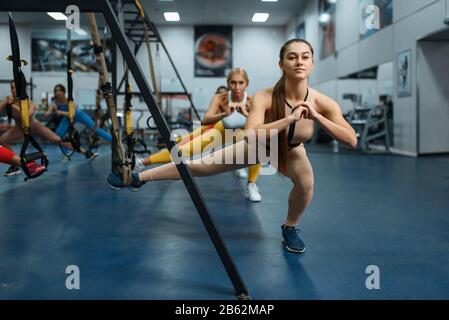 Women doing stretching exercise in gym Stock Photo