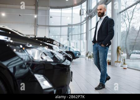 Businessman choosing transport in car dealership Stock Photo