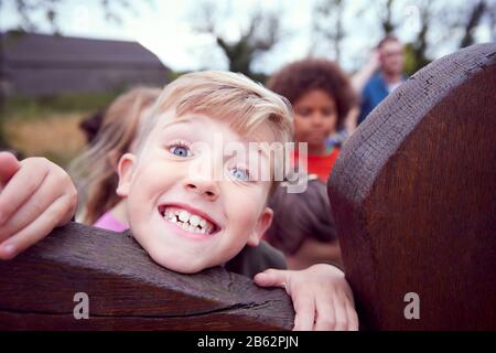 Portrait Of Children On Outdoor Activity Camping Trip Having Fun Playing Game Together Stock Photo