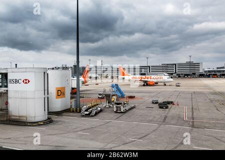 FRANCE PARIS, THE AIRPORT OF CHARLES DE GAULLE, March 17, 2017: Panoramic view of CDG Airport, with parked easyJet airplane and support services Stock Photo