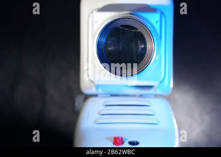 Old slide projector with slide frame photographed in the studio with flash light