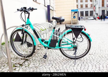 Modern Electric bike at bicycle parking alone on the old city street Stock Photo