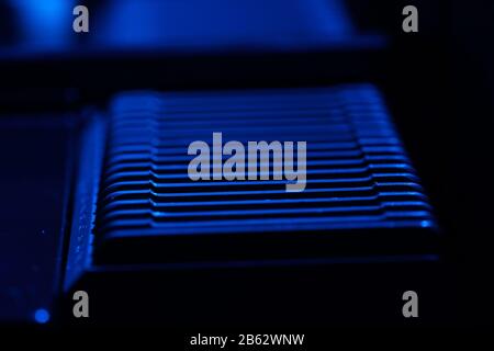Old slide projector with slide frame photographed in the studio with flash light