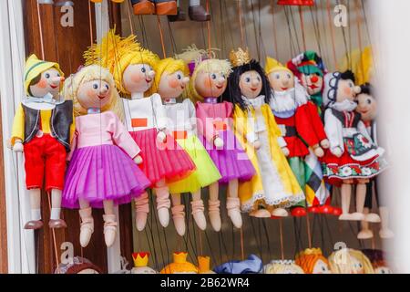 Traditional toy puppets made of wood in souvenir shop Stock Photo