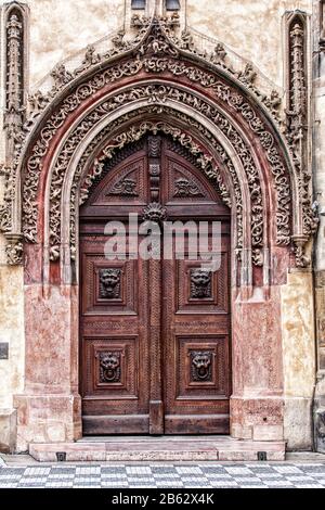 Old door with carved ornaments and frescoes in the temple Stock Photo