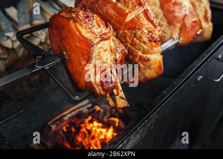 Large chunks of pork cooked on open flame Stock Photo
