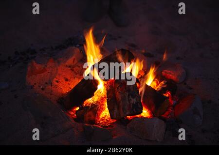 Close Up Of Camp Fire Flames Burning On Beach Stock Photo
