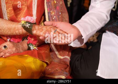 indian bride and groom holding hand at wedding day  Stock Photo