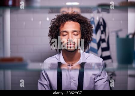 View Through Bathroom Cabinet Of Unhappy Mature Businesswoman Getting Ready For Work Stock Photo