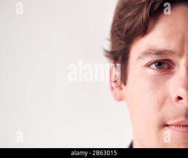 Close Up Portrait Man With Slight Smile Standing In Studio Stock Photo