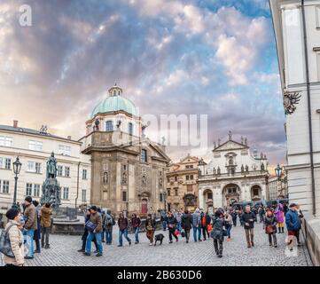 PRAGUE, CZECH REPUBLIC - 18 MARCH, 2017: A huge number of tourists and gapers on the square in front of the Charles Bridge Stock Photo