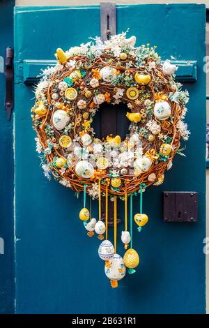 Easter wreath with decorations on the door of the house Stock Photo